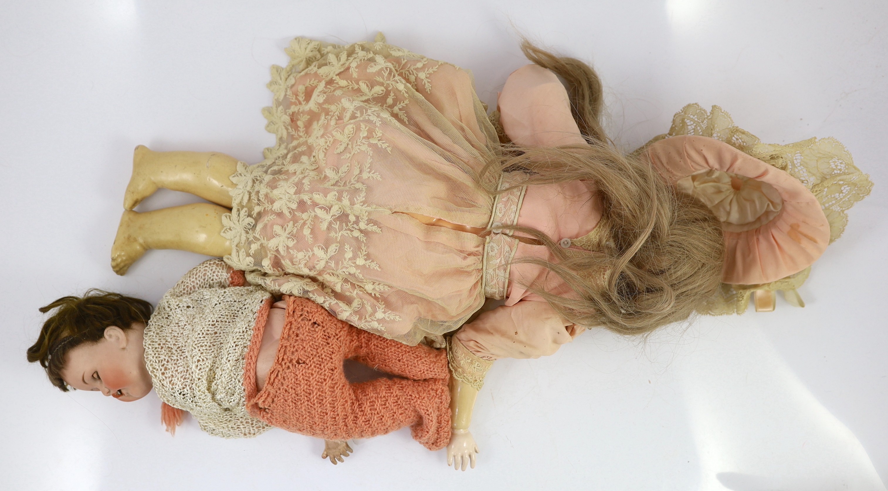 An Armand Marseille bisque doll, mould 390 with sleeping eyes and open mouth, jointed wood and composition body, cream and lace dress and matching bonnet, 22in., and a German Bebe Elite bisque doll